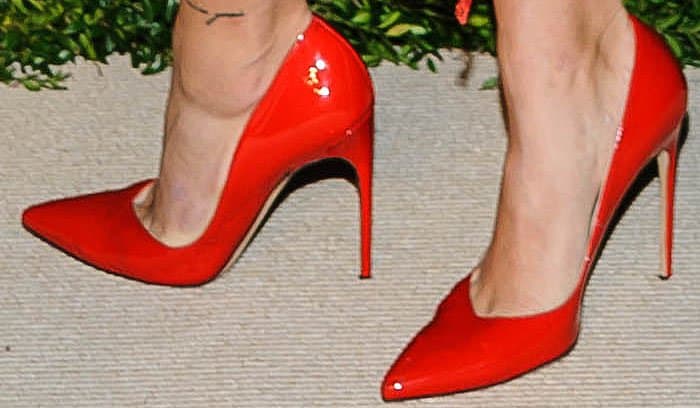 Hailey Baldwin completes her look with striking red-orange Brian Atwood 'Marella' patent pumps