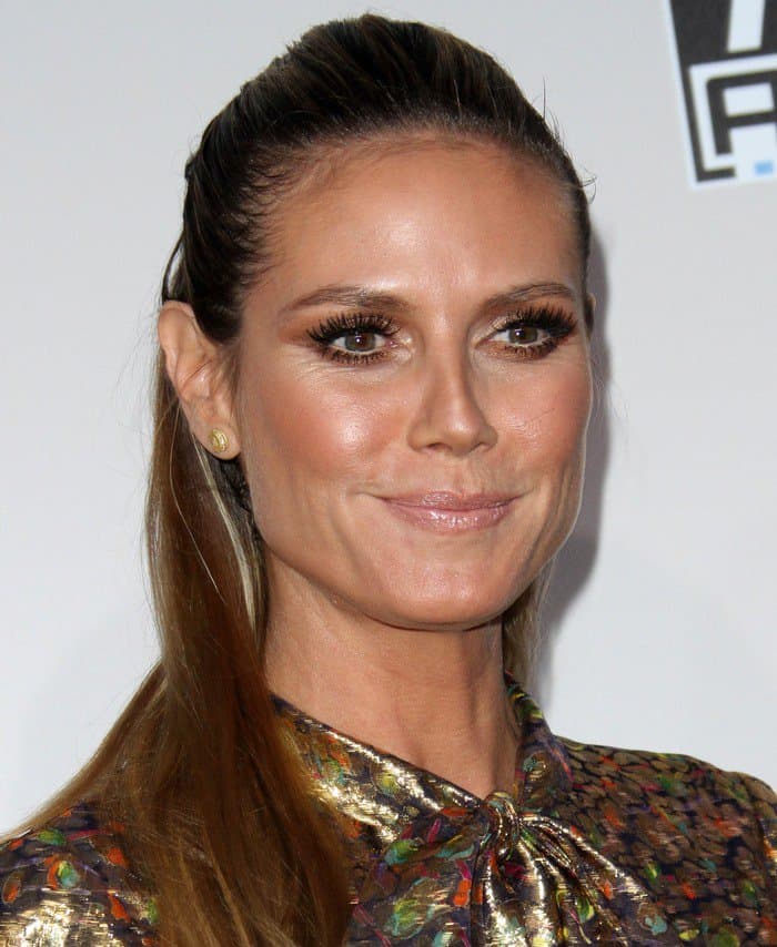 Heidi Klum's outfit was completed with a sultry smokey eye, a subtle nude lip, and a sleek ponytail