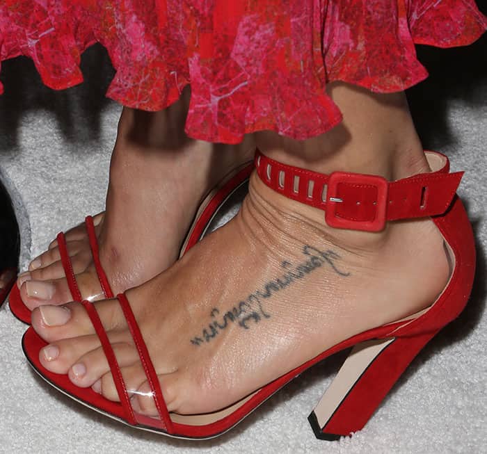 Jenna Dewan-Tatum's meaningful foot tattoo, honoring her wedding vows, is on display as she elevates her look with bold red Tamara Mellon heels