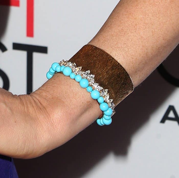 Jessica Chastain adds a pop of color to her look with turquoise beaded bracelets and a statement cuff