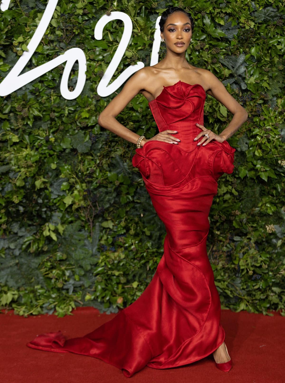 Jourdan Dunn in a red Andrea Brocca dress attends The Fashion Awards 2021