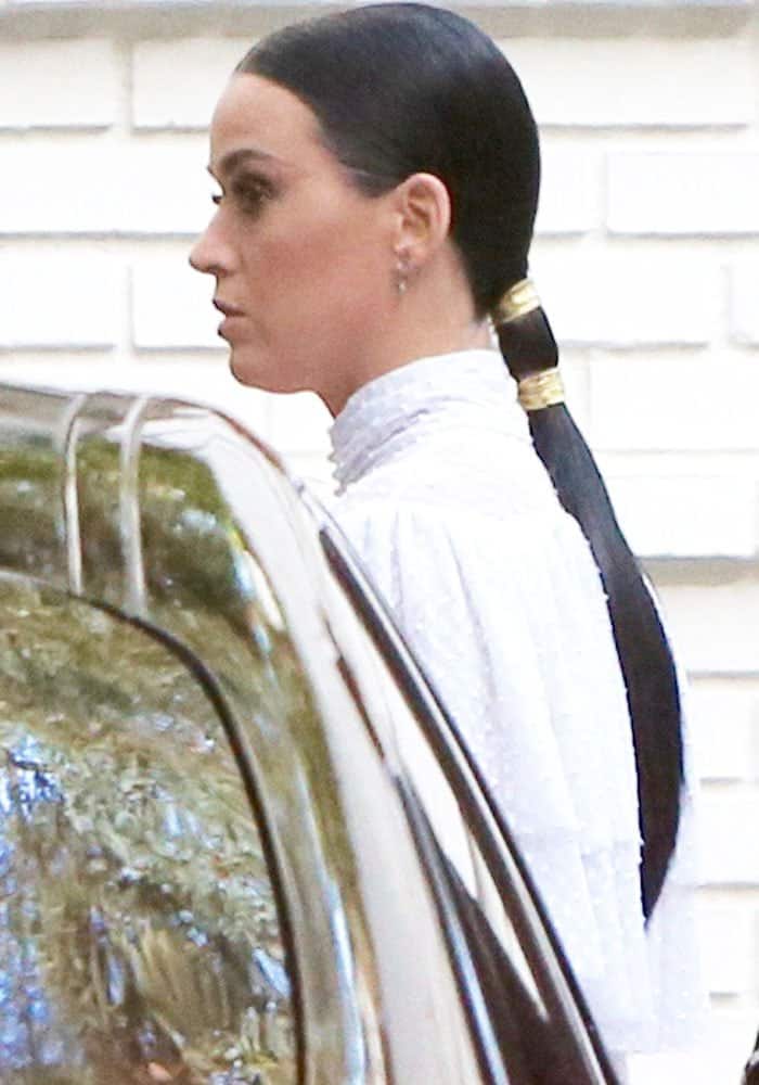 Katy Perry arrives at the 2016 CFDA Vogue party in Los Angeles, sporting a sleek ponytail wrapped in gold detail