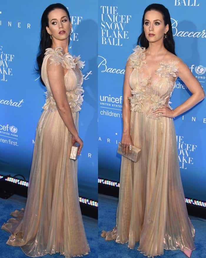 Katy Perry stuns in a sheer gold Marchesa gown with floral appliqué details and pleated fabric