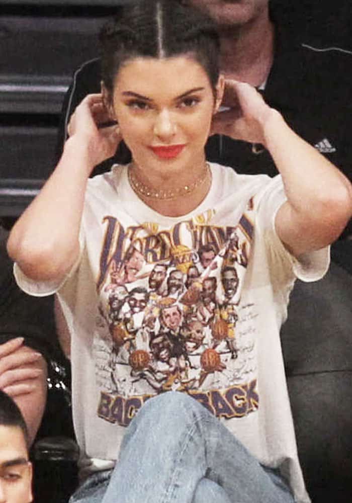 Kendall Jenner wore a Lakers t-shirt with red lipstick while watching the team's home opener game against the Houston Rockets
