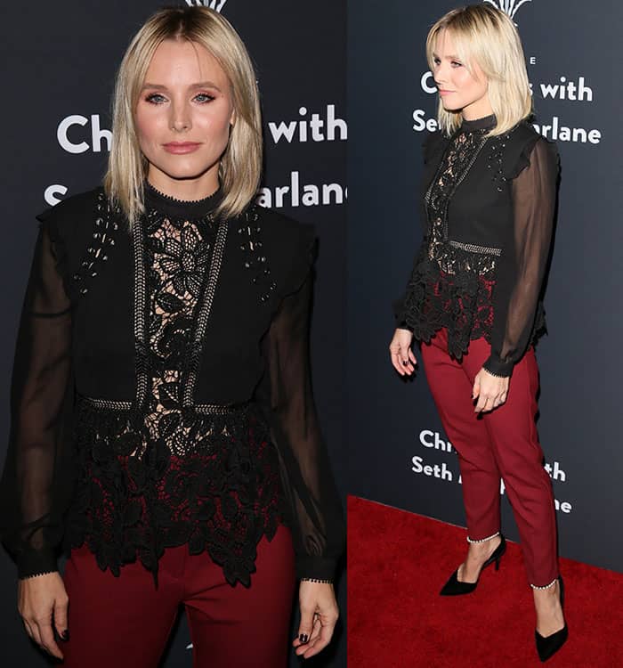 Kristen Bell likely chose these black pointed-toe pumps with pearl ankle straps for their elongating effect, as the sleek design and pointed silhouette create the illusion of longer legs while complementing her tailored burgundy trousers