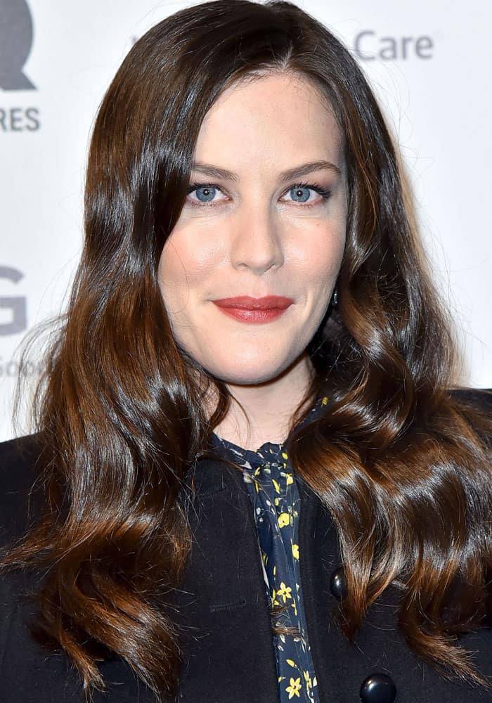 Liv Tyler stuns with her glossy waves and soft makeup, highlighting her luminous skin and bold red lips