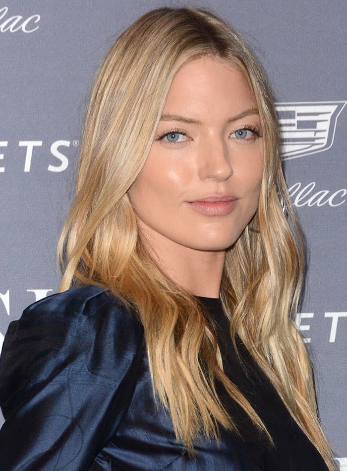 Capturing grace and beauty, Martha Hunt lets her golden locks flow in loose waves, complementing her natural makeup look