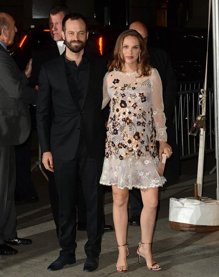 Natalie Portman dazzles in a floral-embroidered Rodarte dress, complemented by satin sandals, while accompanied by her husband Benjamin Millepied