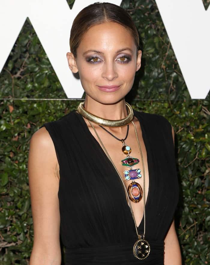 Nicole Richie accessorizes with bold, statement jewelry, including layered necklaces featuring vibrant gemstones and gold accents