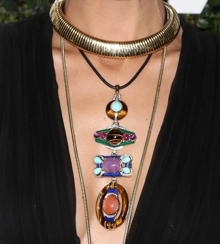Nicole Richie’s striking necklace features a series of vibrant gemstones, including turquoise, amethyst, and tiger's eye, intricately set in gold and accented with diamonds