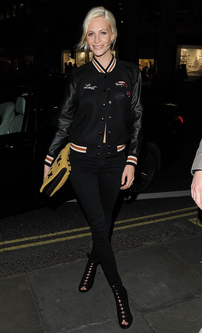 Poppy Delevingne nails casual chic with a Coach varsity jacket, high-waisted skinny jeans, and lace-up booties—an effortlessly cool look for the evening