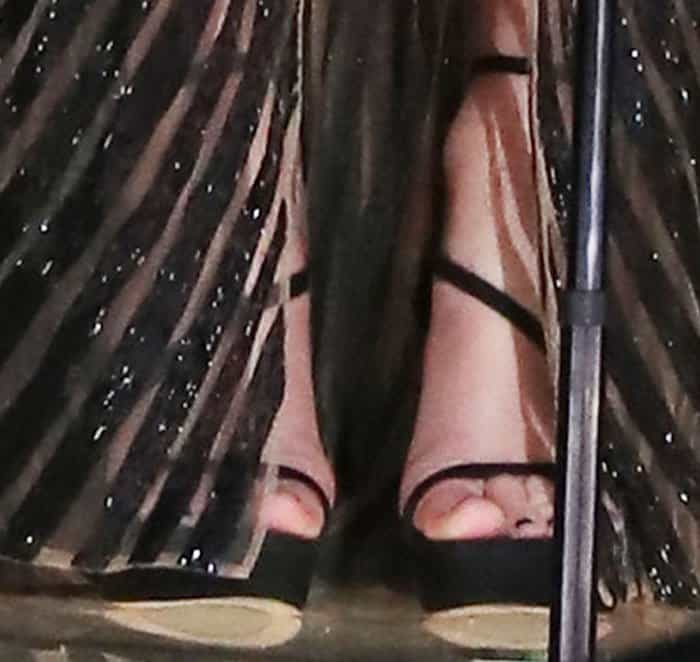 Taylor wears a customized version of Stuart Weitzman's Sultry sandals