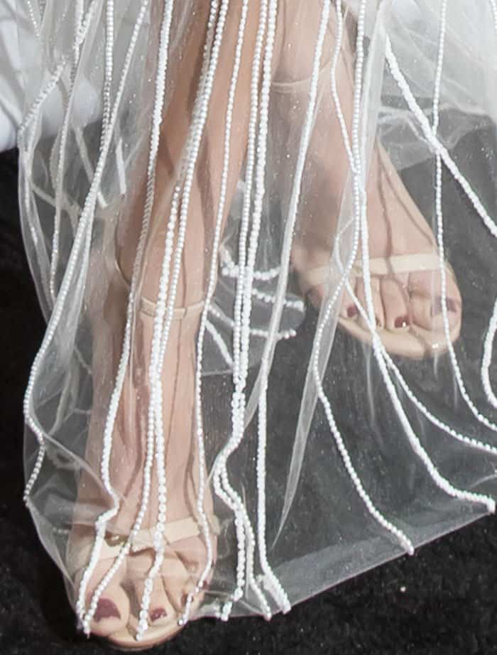 Victoria Justice completes her look with the classic Stuart Weitzman "Nudist" sandals