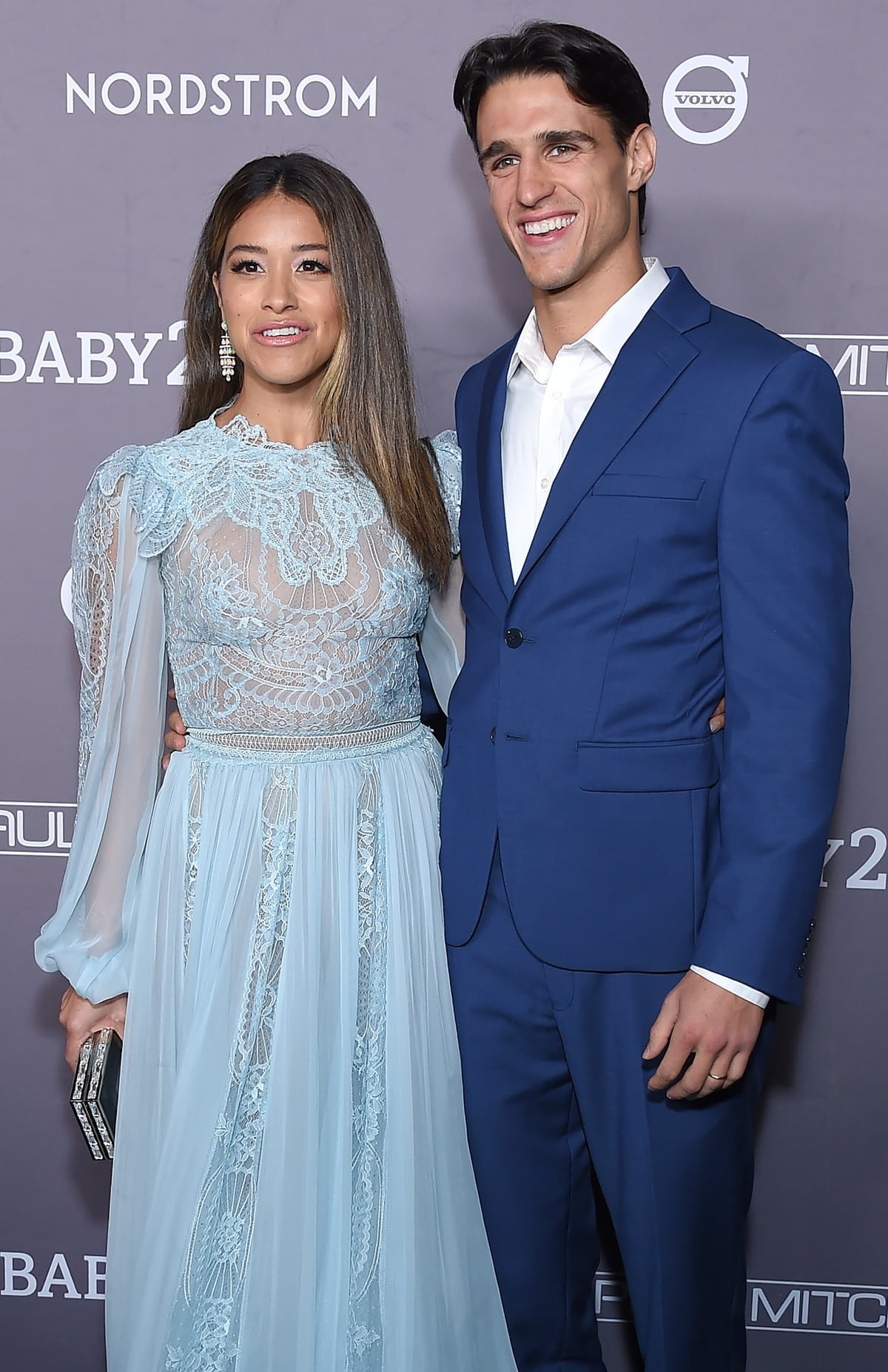 Gina Rodriguez in a light blue Zuhair Murad lace dress and Goshwara opal earrings with her husband Joe Locicero at the 2019 Baby2Baby Gala