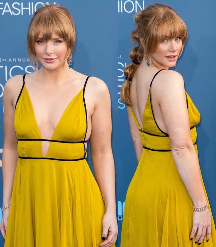 Bryce Dallas Howard's dress is a bold mustard yellow gown featuring a deep V-neckline and thin black piping along the straps and waistline