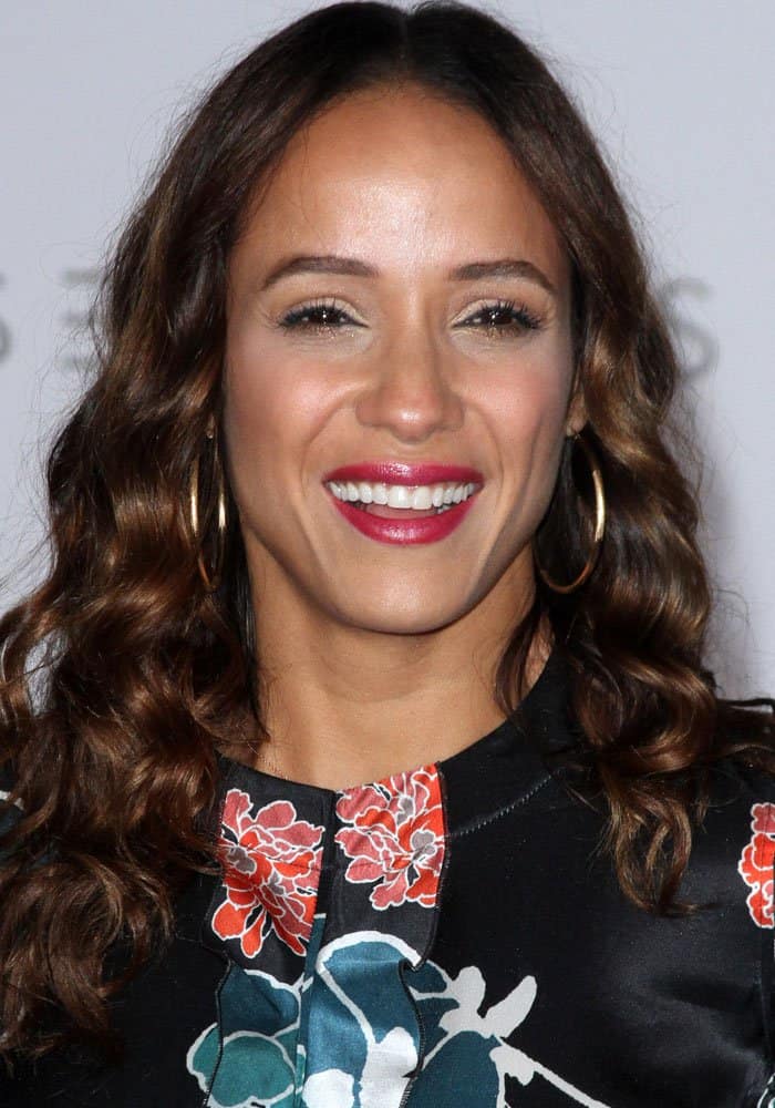 Dania Ramirez attends the "Passengers" premiere in Westwood, California, wearing a floral dress with bold hoop earrings