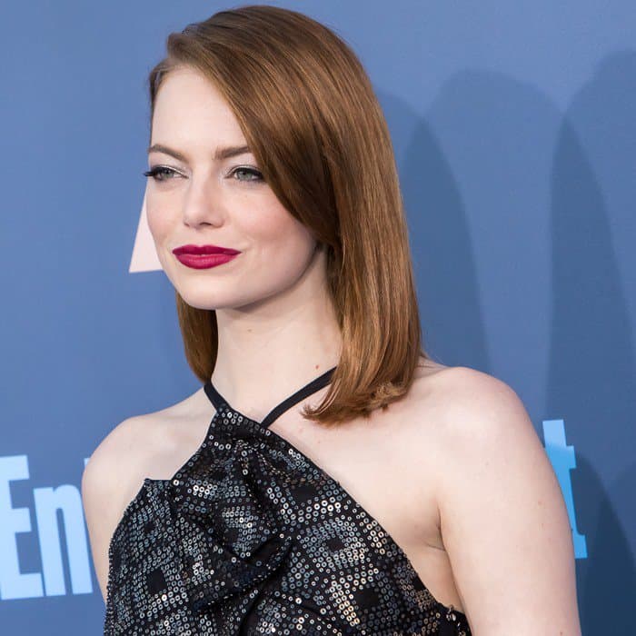 Emma Stone pairs her sleek auburn bob with a bold berry lip and subtle eye makeup