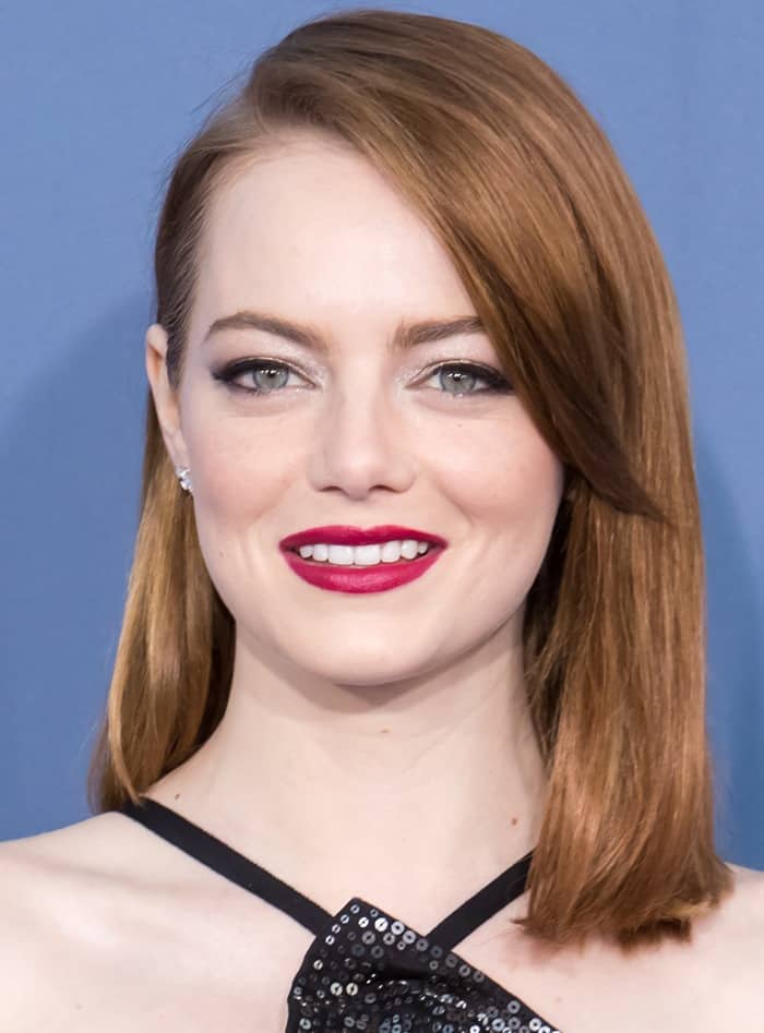 Emma Stone stuns with her sleek auburn bob and striking blue eyes