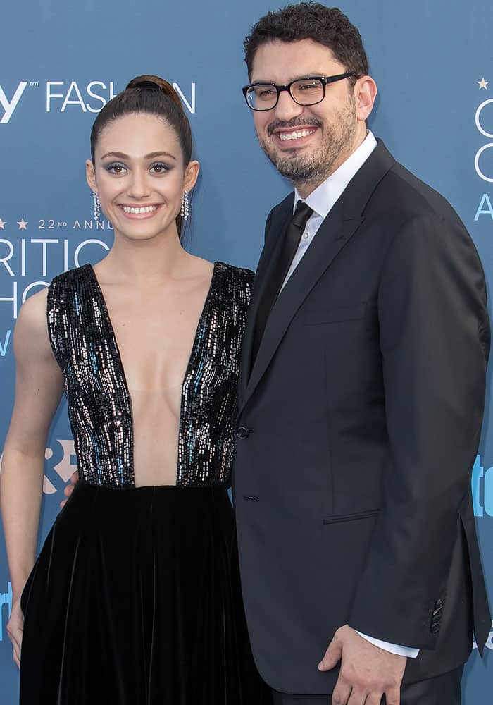 Emmy Rossum poses with her fiancé, Sam Esmail, at the Critics' Choice Awards, looking stunning in a Giorgio Armani sequin-embellished gown, while Sam complements her in a classic black suit