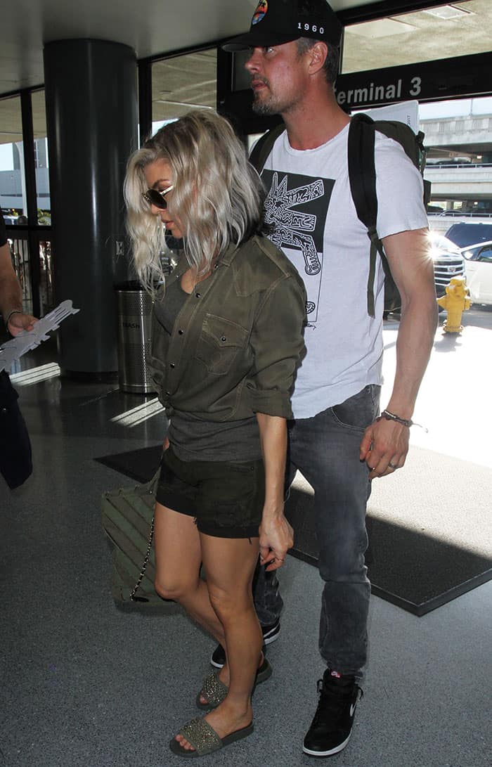 Fergie and Josh Duhamel keep it casual chic as they depart from LAX on December 29, 2016, with Fergie in a military-inspired outfit and Josh in a laid-back graphic tee and jeans