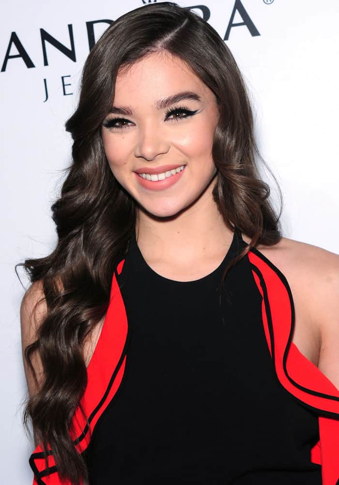 Hailee Steinfeld looks stunning with her long, wavy hairstyle and radiant smile, perfectly complemented by her bold winged eyeliner and soft pink lips at the 2016 Billboard "Women In Music"