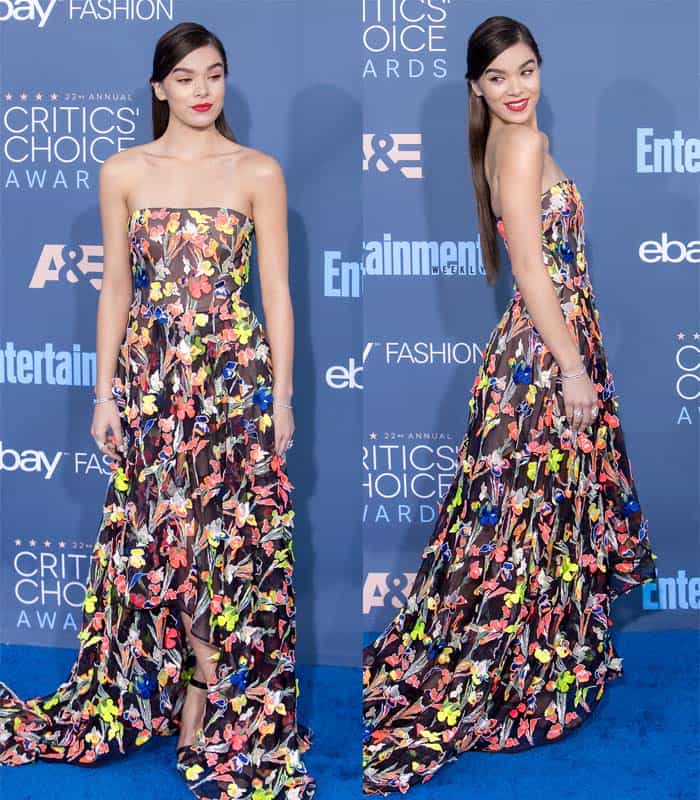 Hailee Steinfeld dazzles in a vibrant, strapless Jason Wu gown adorned with colorful floral appliques at the Critics' Choice Awards, perfectly matching her bold red lips and sleek hairstyle