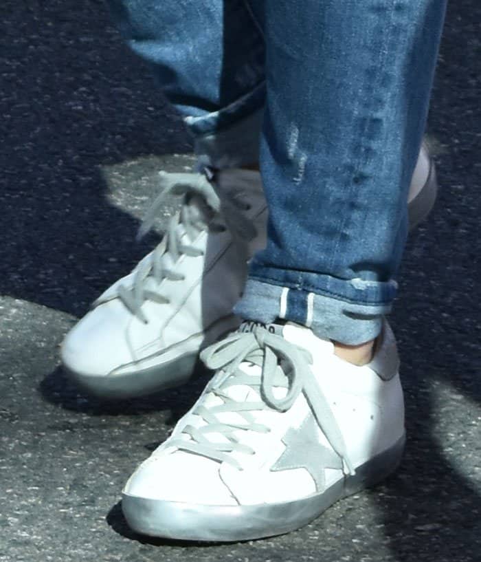 Hilary Duff's Golden Goose "Super Star" sneakers are characterized by their signature distressed look, which includes scuffed soles and worn edges