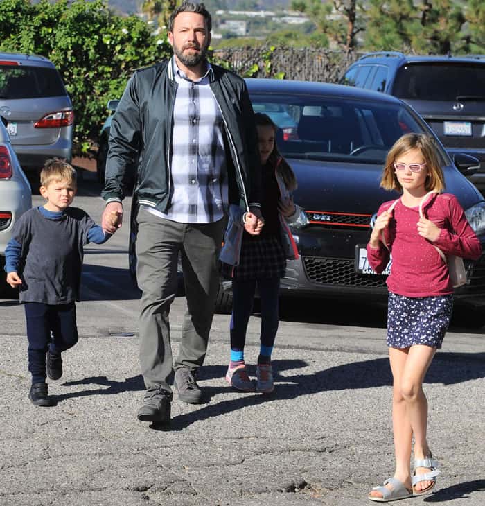 Ben Affleck steps out with his children in Brentwood, casually dressed in a plaid shirt, bomber jacket, and relaxed-fit pants for a family day out