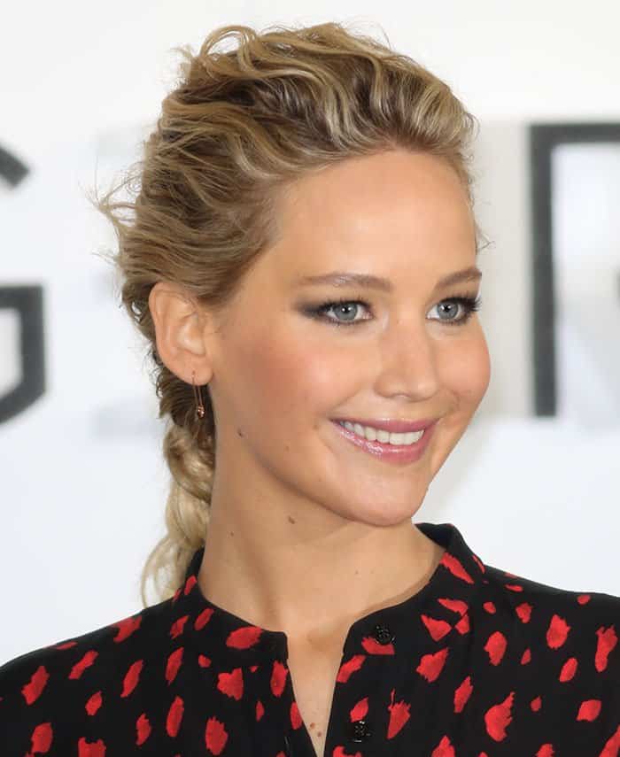 Jennifer Lawrence with her hair pulled back to show off her safety pin earrings