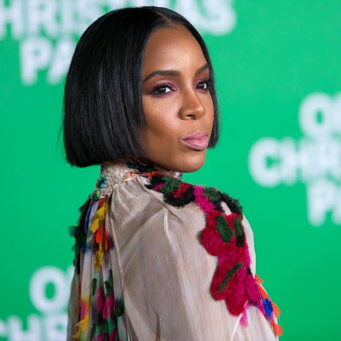 Kelly Rowland confidently shows off her sleek bob and colorful Chloé dress, though a visible bra strap slightly distracts from her otherwise flawless look