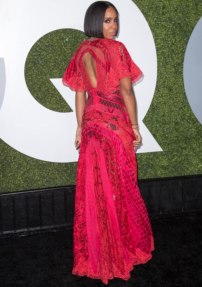 Her red beaded gown features an extremely plunging neckline and sheer lace panels