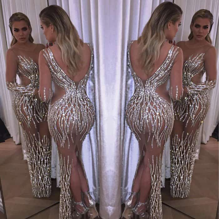 Khloé Kardashian gives a stunning view of her embellished Yousef Aljasmi gown, showcasing its intricate detailing from all angles as she poses in front of a mirror