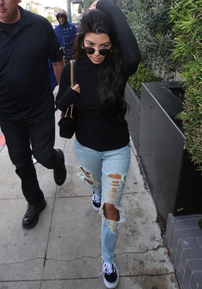Kourtney Kardashian shows how to wear black and white Vans Old Skool sneakers with a cute outfit