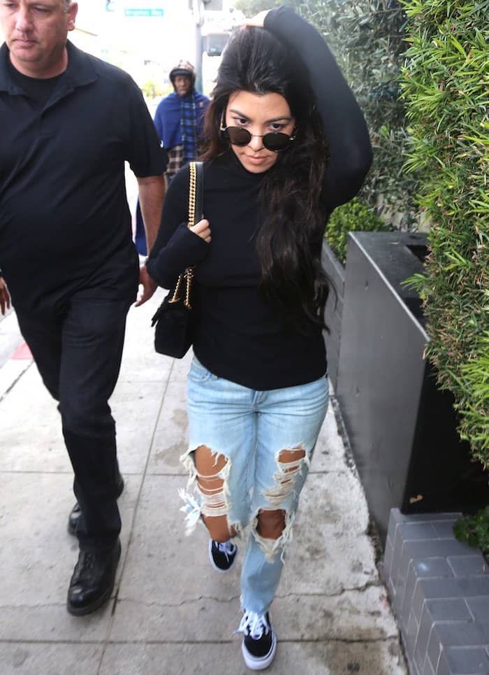 Kourtney Kardashian totes a Gucci Marmont velvet mini bag and rocks Garrett Leight Wilson sunglasses