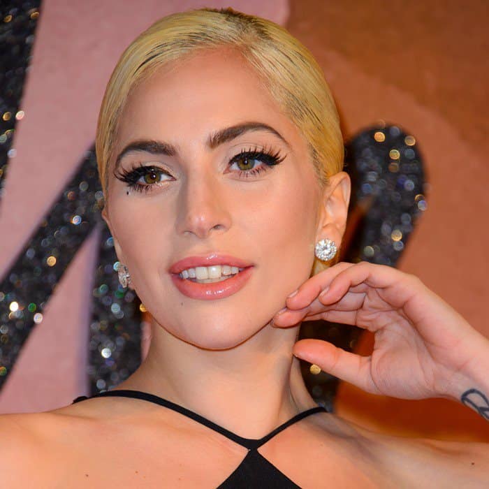Her bold lashes accentuate Lady Gaga's striking hazel eyes, while her diamond stud earrings add an extra touch of sparkle to her glamorous look