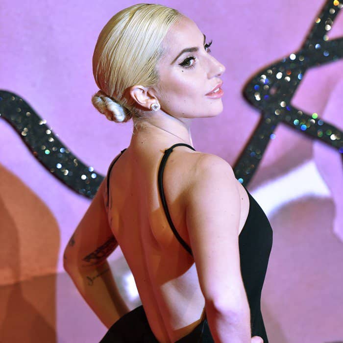 Lady Gaga's sleek low bun perfectly complements the open-back design of her black gown