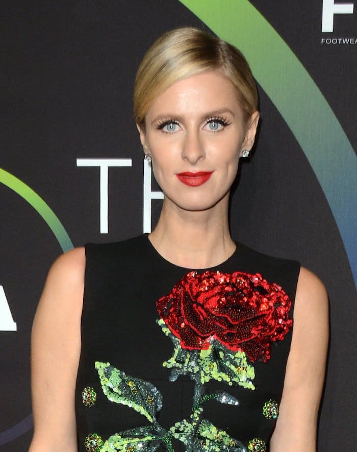 Nicky Hilton goes for red lips and a sleek updo for the 30th Footwear News Achievement Awards