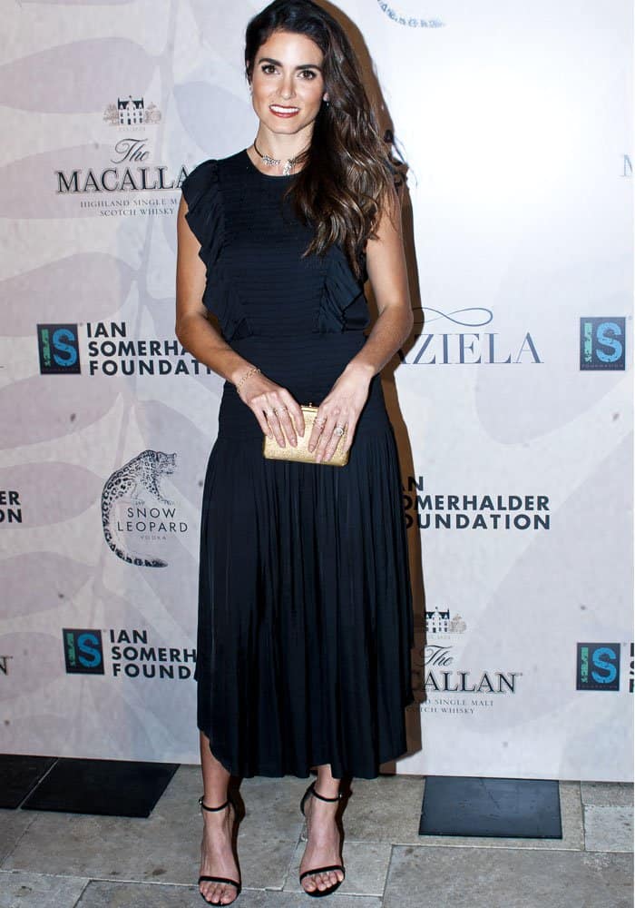 Nikki Reed stuns in a ruffled black Ulla Johnson "Coco" dress paired with classic Stuart Weitzman "Nudist" sandals at the Ian Somerhalder Foundation Benefit Gala in Chicago