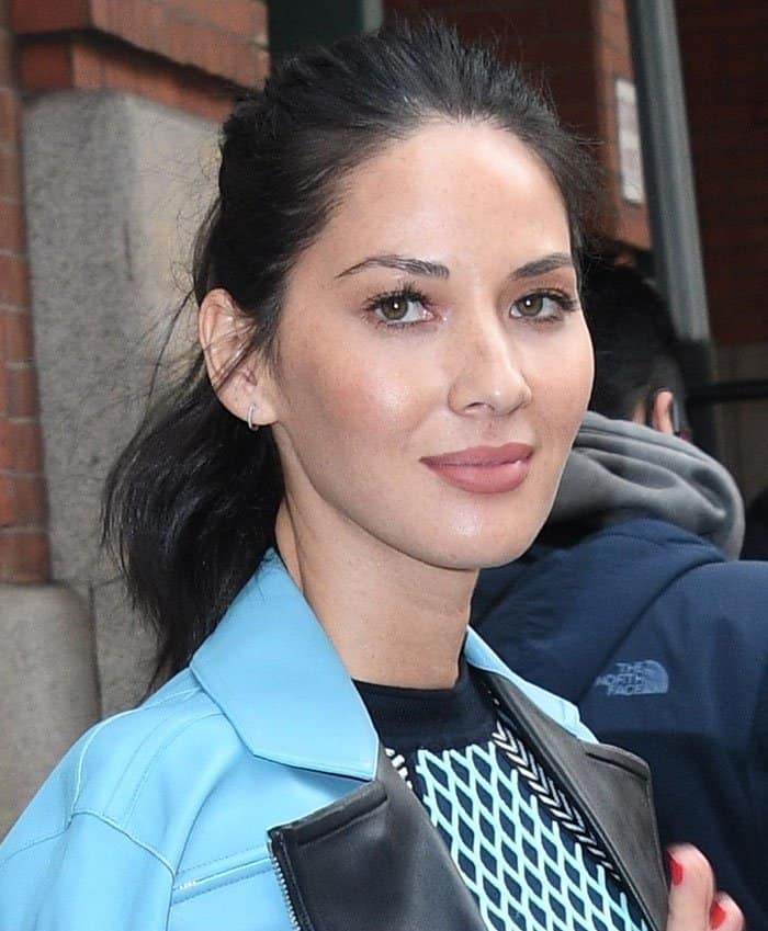 Olivia Munn keeps her look polished with a sleek, pulled-back hairstyle and minimalist small hoop earrings