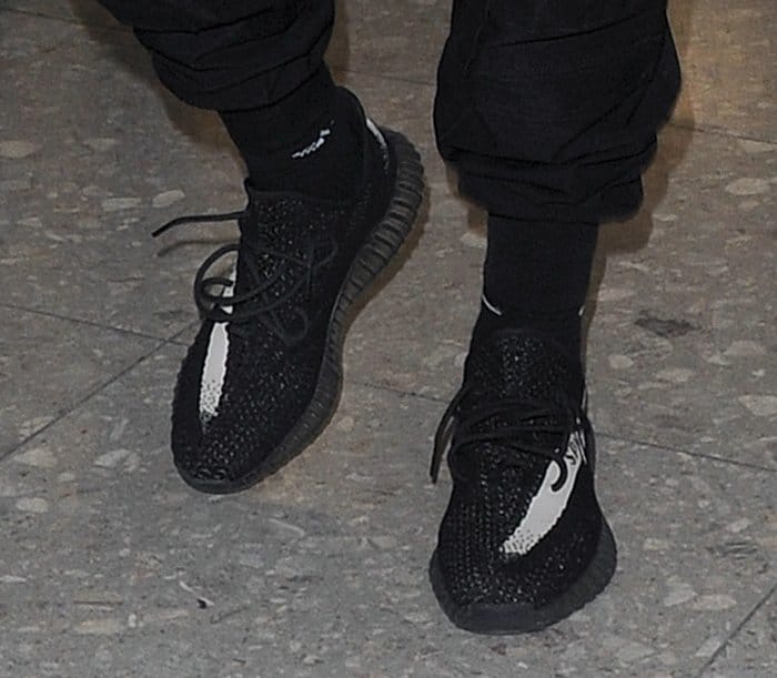 Kanye West wearing Yeezy Boost 350s with a white stripe