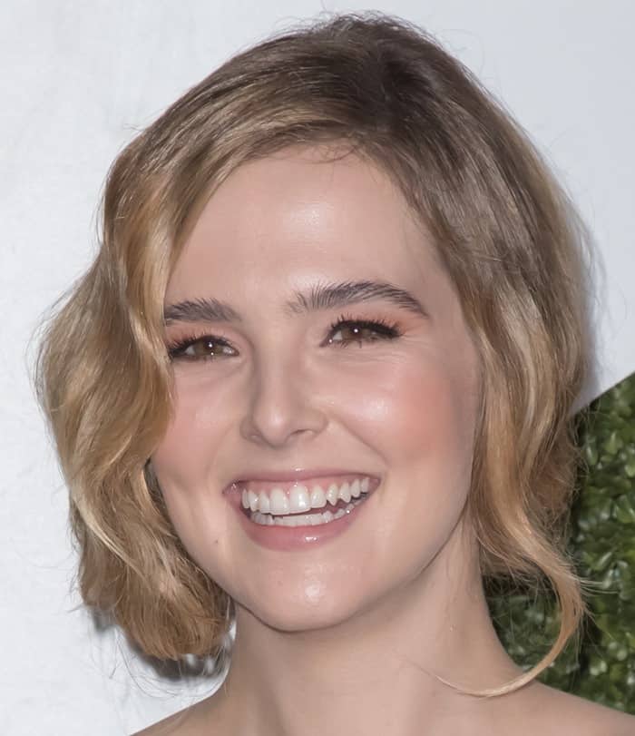 Zoey Deutch radiates with her warm hazel eyes and a bright smile