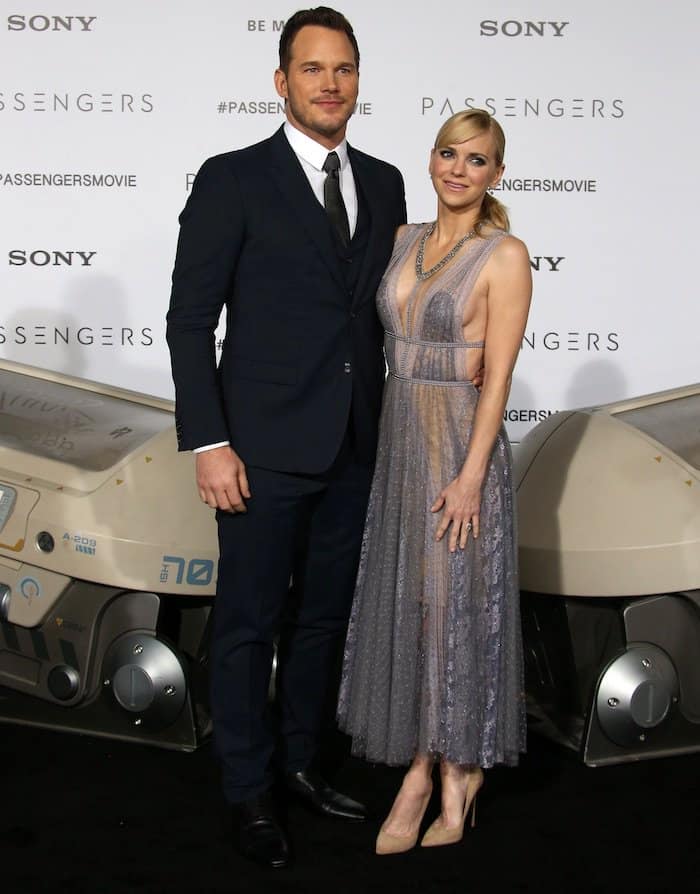 Anna Faris in a Reem Acra dress, Jimmy Choo shoes, and Le Vian jewelry supports her husband Chris Pratt in a navy blue Dolce & Gabbana suit at the movie premiere of "Passengers"