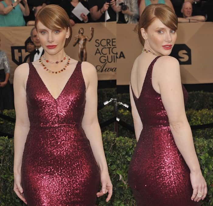 Bryce Dallas Howard glows in a form-fitting, deep red sequin gown with a plunging neckline and a classic sleeveless silhouette