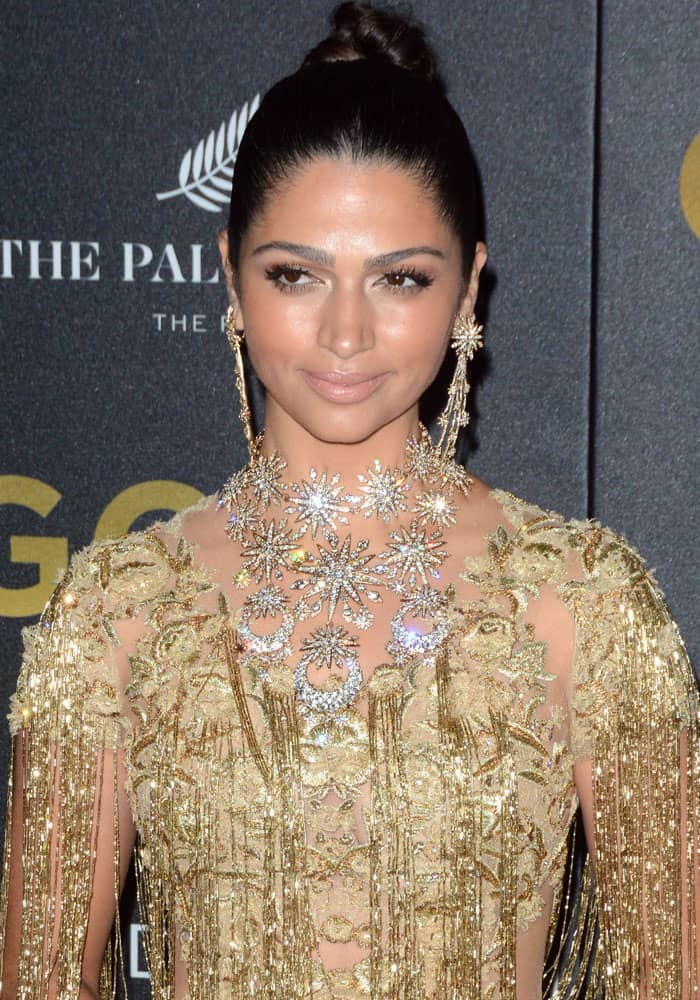 Camila Alves turned heads in a dazzling gold Marchesa gown paired with an elegant pair of dangly earrings and a draped necklace at the world premiere of "Gold"