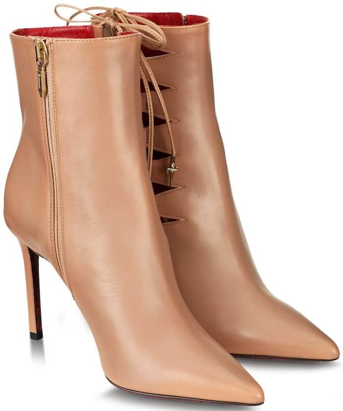 Cesare Paciotti’s ‘Sveva’ booties showcase a sophisticated pointed-toe design with unique cutout lace-up detailing, blending elegance with edgy allure