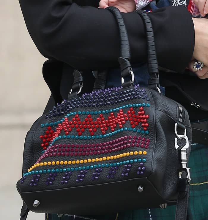 Gwen Stefani carries the Christian Louboutin Panettone Small Spike Bag, featuring colorful spike embellishments and a playful textured leather design