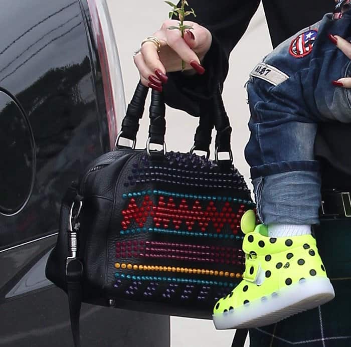 Gwen Stefani carries the Christian Louboutin Panettone Small Spike Bag, featuring colorful spike embellishments and a playful textured leather design
