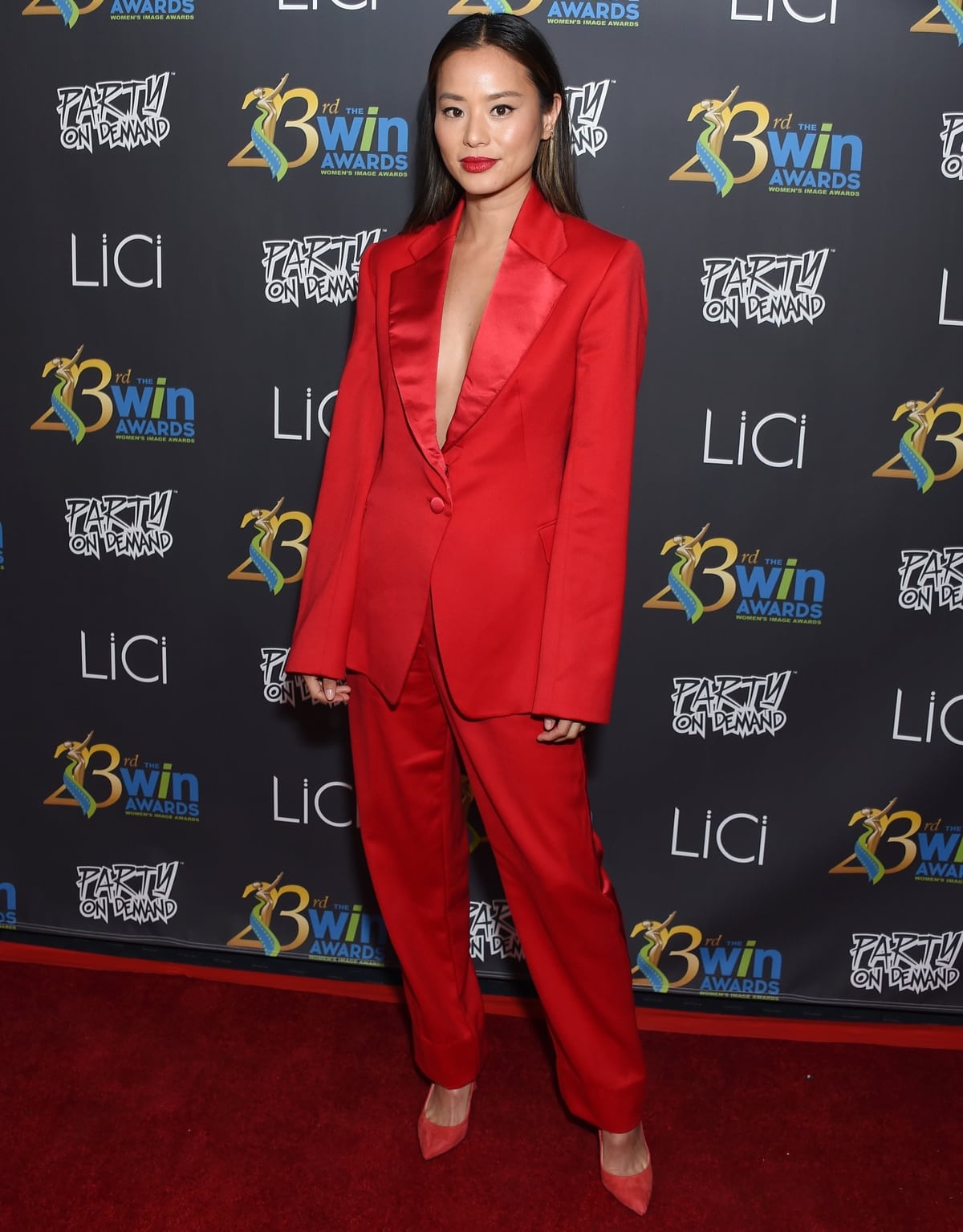 Jamie Chung styled pointy red pumps with a sexy suit jacket and matching pants for the 23rd Women's Images Awards