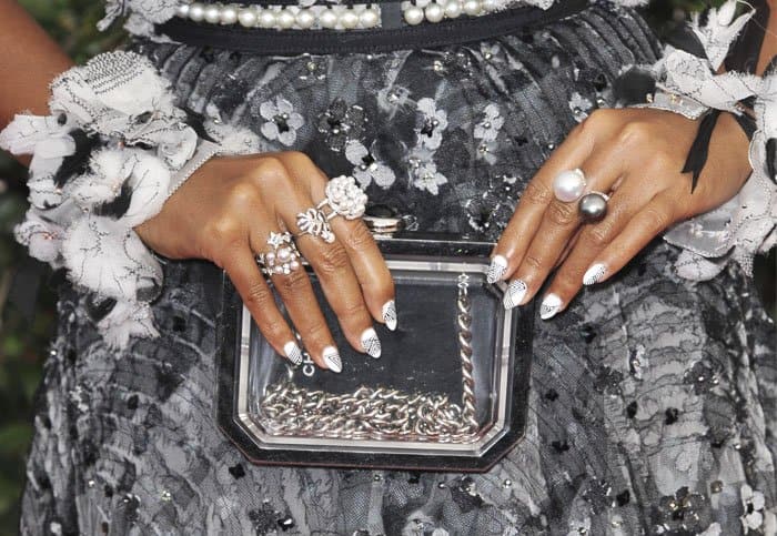 With an eye for detail, Janelle Monáe displays her Chanel accessories and playful nail art, highlighting her impeccable taste and style