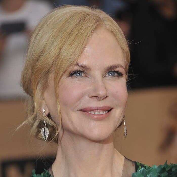 Nicole Kidman wearing a playful green gown with a plunging neckline